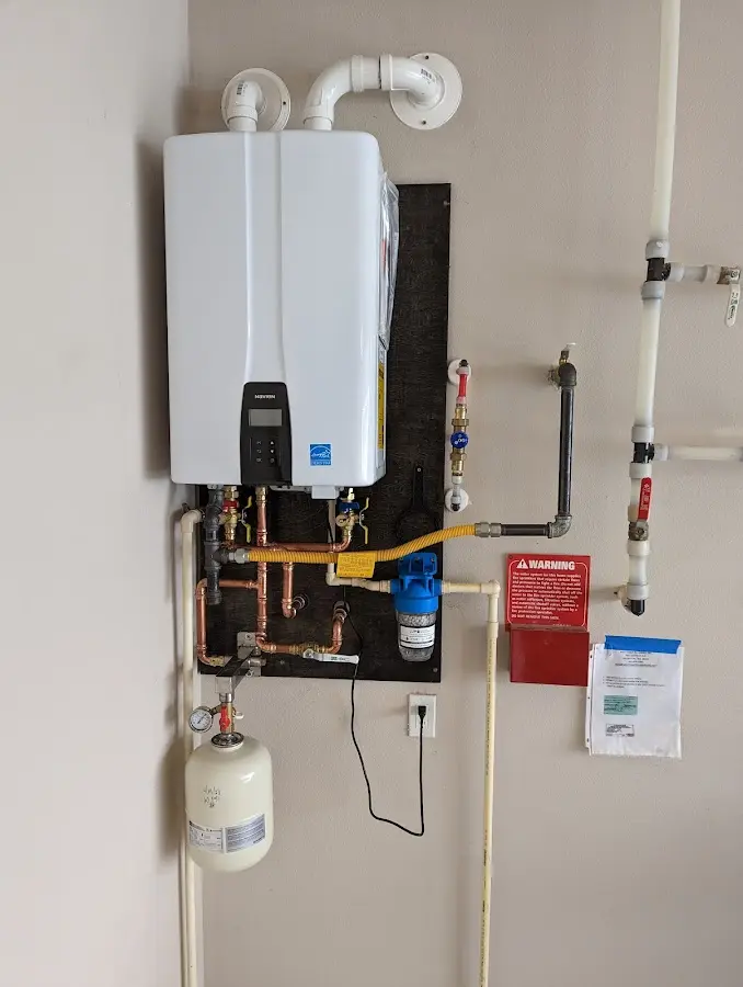 Professional plumber installing copper piping in a Phoenixville home